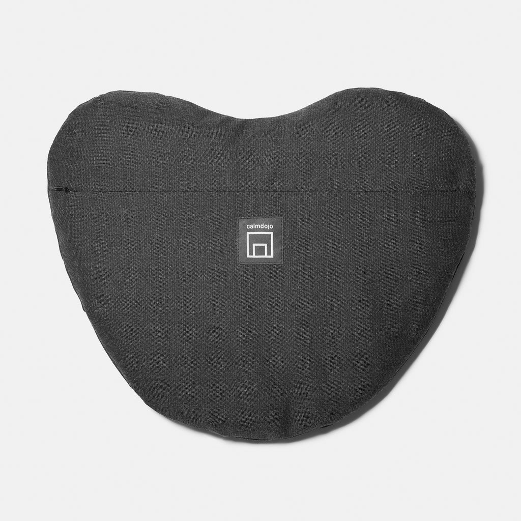 reverse of heart shaped pillow with logo label and zip visible.