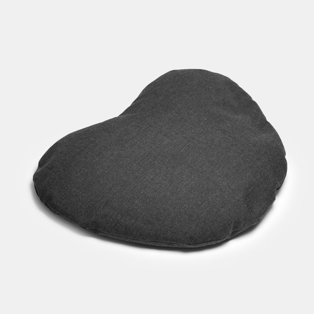 heart shaped gray pillow shown at a three quarter view.