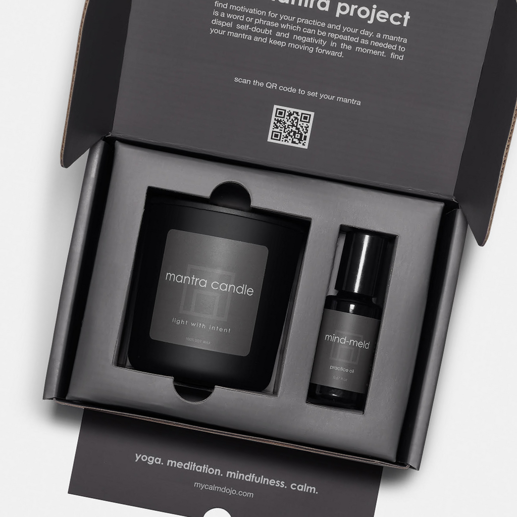 closeup of interior of the mantra project kit with candle and mind-meld product.
