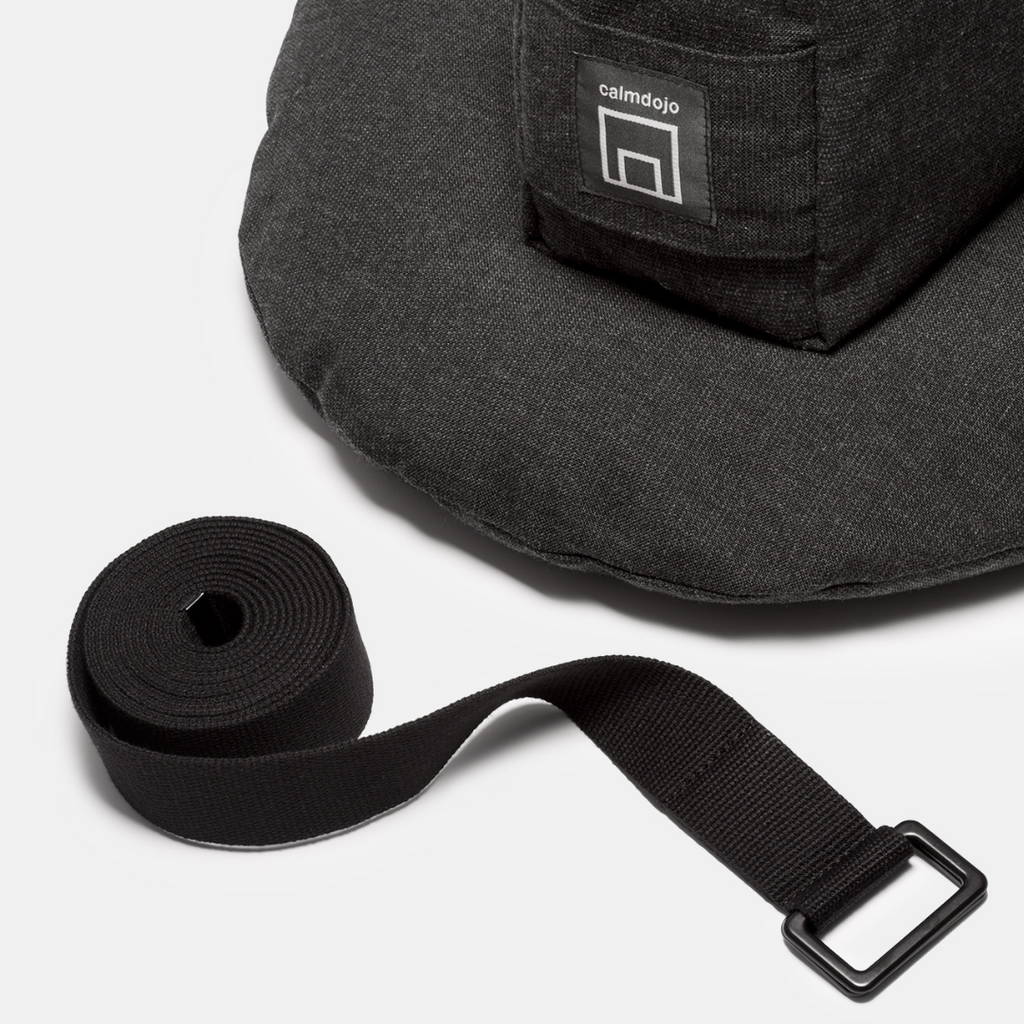 group shot with yoga strap in the front and a gray pillow and bolster in the background.