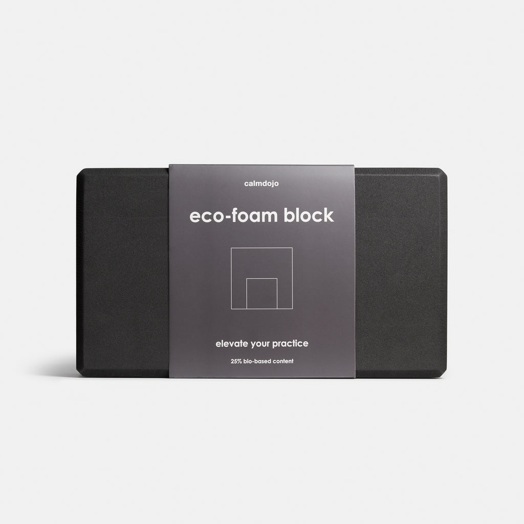 front view of yoga block with gray packaging belly band against a white background.