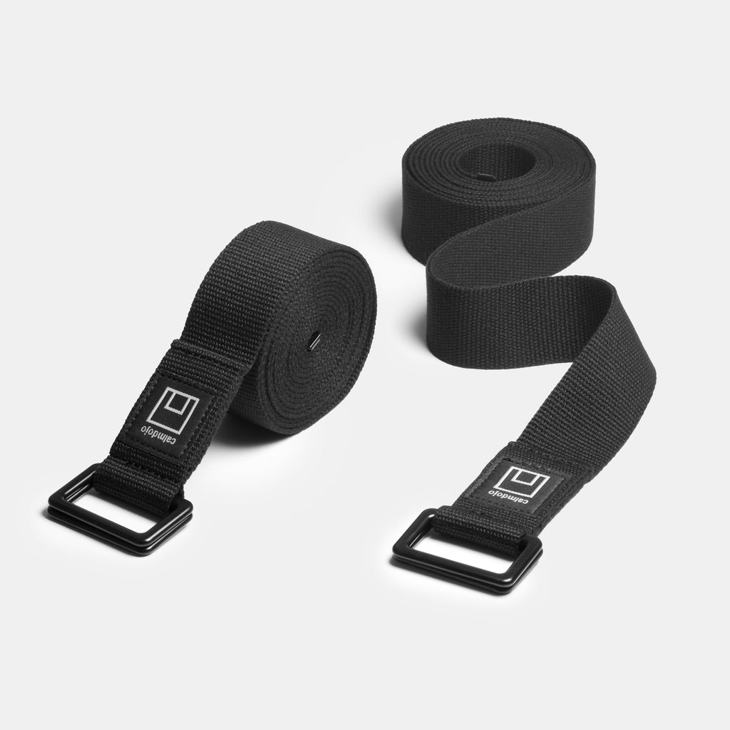 Two black yoga straps side by side.