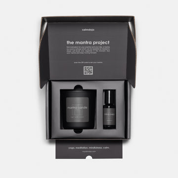 gray shipping kit interior with black candle jar with label and mind-meld product.